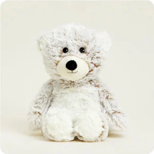 cream colored bear with long fur, white belly and muzzle, black nose and eyes