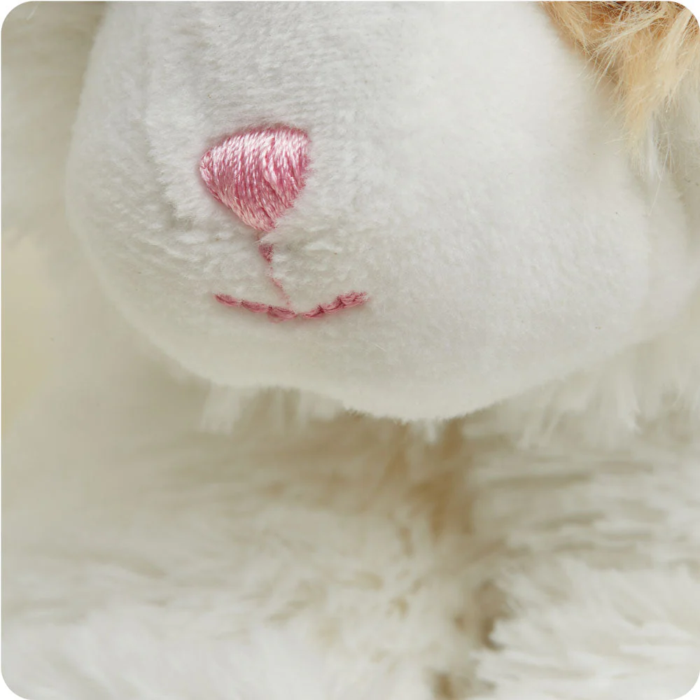 close up of longer body fur and shorter cream fur on face, pink embroidered nose and mouth
