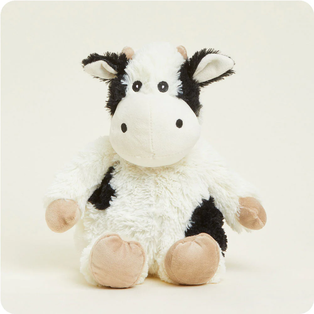 white cow stuffie with black spots at sides and beige hooves.