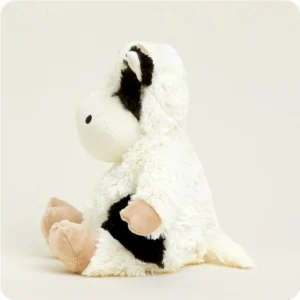 side view of cow, mainly white body, short tail