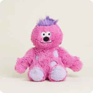 monster stuffie with mid length pink fur, purple tuft of hair, lavender spots and bottom of feet