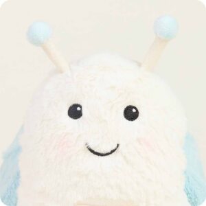 close up of snail face, cream fur with black embroidered eyes and smile, antennae with blue balls at top