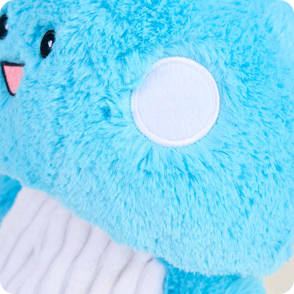 closeup of mid length blue fur and shorter white spot on cap with satin stitch around