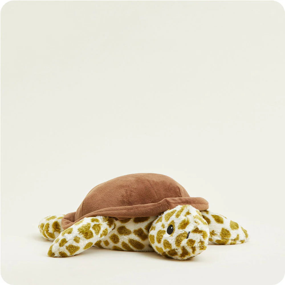 turtle stuffie with cream fur with dark olive green spots and solid brown shell