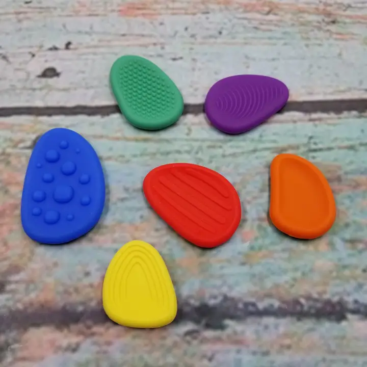 6 multi colored flat "stones" with different textures