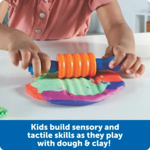 hands using a roller with dough
