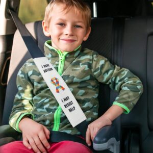 child in car with seat belt cover that says "i have autisim, i may resist help"