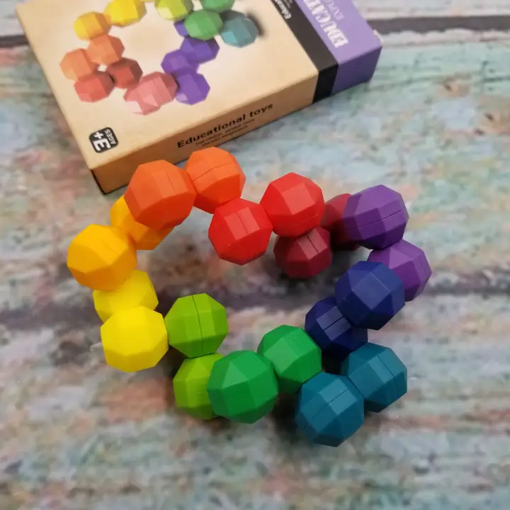 rainbow colored uniformly shaped stones that are connected but can move around