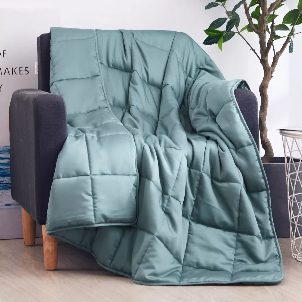 muted teal blanket with square stitching