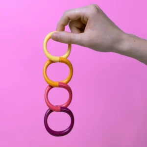 A magnetic fidget coil hanging from someones hand