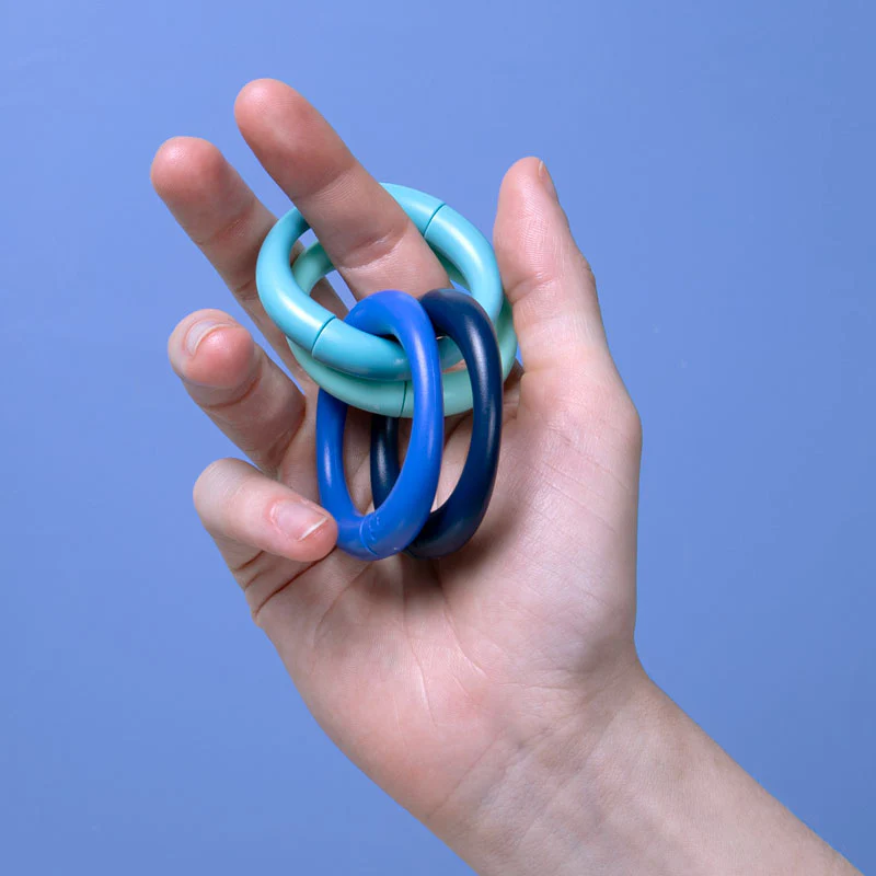 A magnetic fidget coil wrapped around someones fingers
