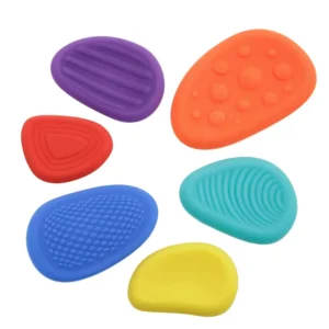 flat purple, orange, teal, yellow, blue and red silicone stones of different sizes with different textures
