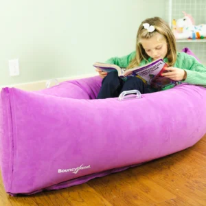 girl reading in canoe shaped chair that compresses her sitting in the middle