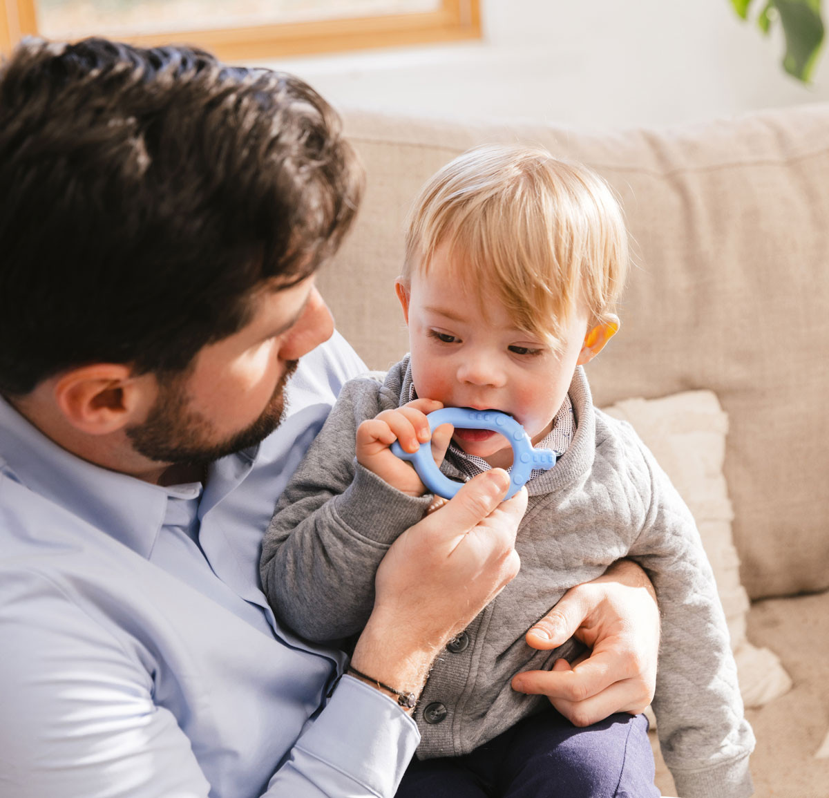 a man and toddler with a blue chew