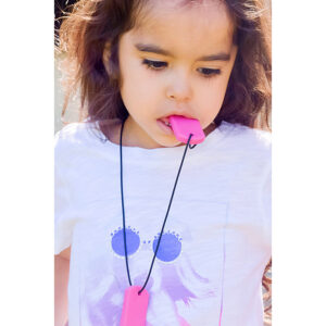 young girl with necklace on, one pendant hanging and the other in her mouth