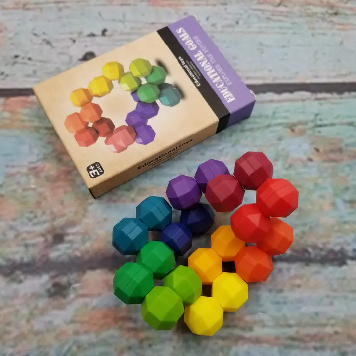 rainbow colored uniformly shaped stones that are connected but can move around