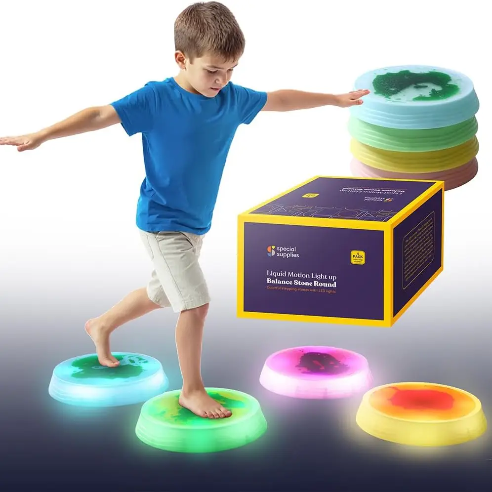 boy stepping on 4 light up stepping stones, blue, green, pink and yellow.