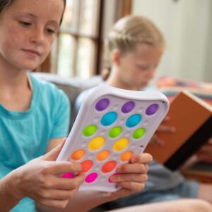 young person holding white plastic toy with 18 soft popping bubbles that are rainbow colored