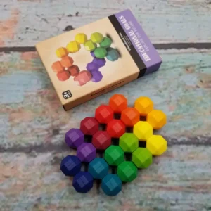 rainbow colored uniformly shaped stones that are connected but can move around, flat layout