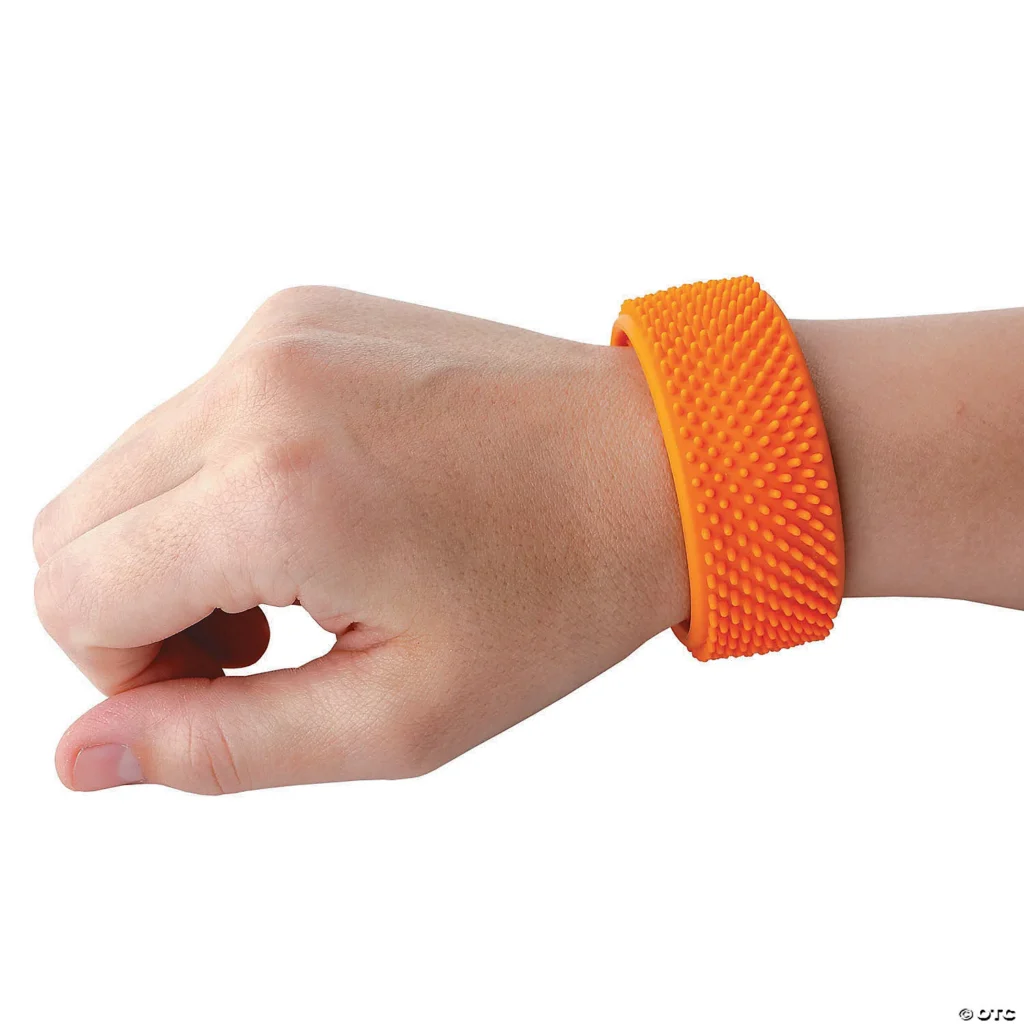 Orange slap bracelet around a person's wrist, has soft texture on both sides