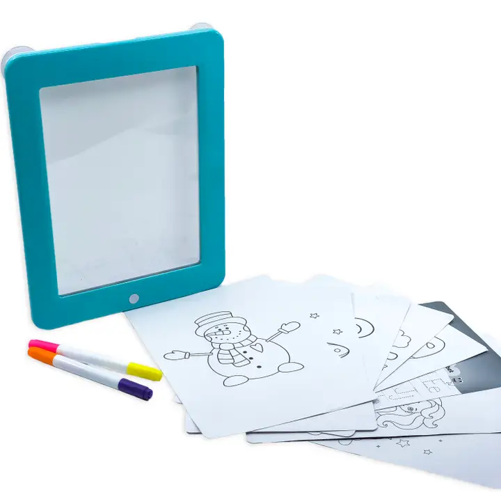 blue framed white board with markers and sheets of papers with black and white drawings on them