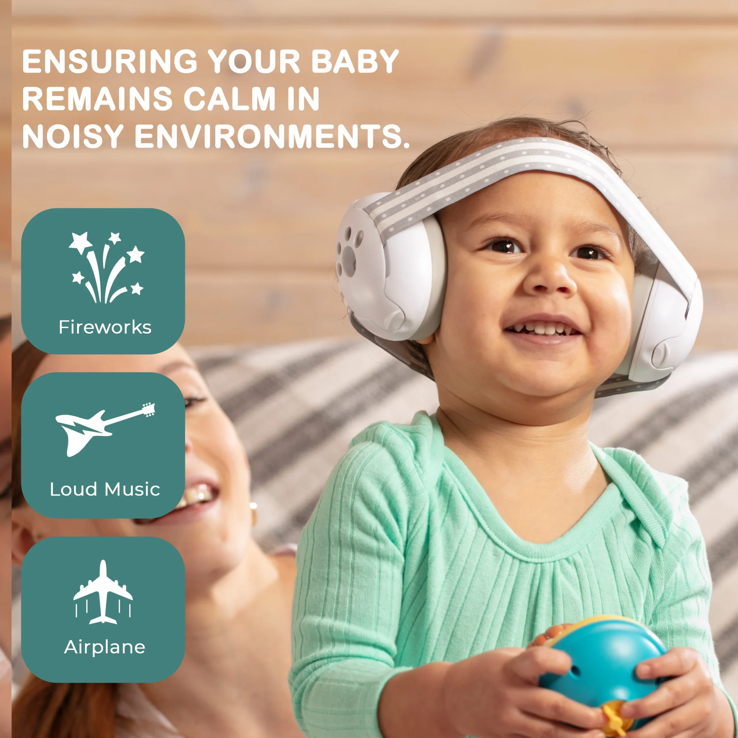baby wearing safety earmuffs smiling