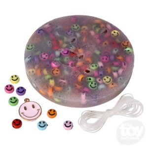 multicolored smiley face beads in a round wax disk with pink enamel smiley face charm
