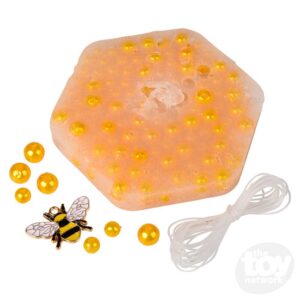 orange beads in wax honeycomb with bee charm and string