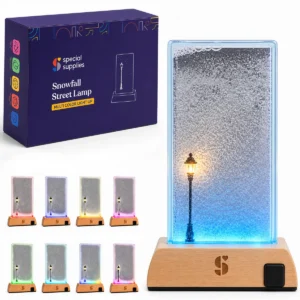 woodn base with a rectangular window with snowflakes inside, lit by a street lamp that glows different colors