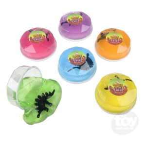 faceted clear plastic container with colored slime inside and a plastic dinosaur
