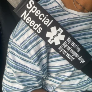 seat belt cover on a seat belt that says "special needs, may resist help, may not recognize danger, may not respond"