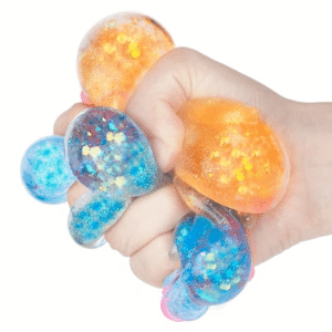 hand squishing two toys shows glitter inside