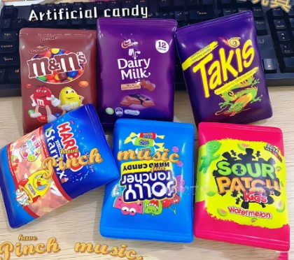 squishy printed to look like various snack bags like m&ms, takis, sour patch kids and jolly ranchers