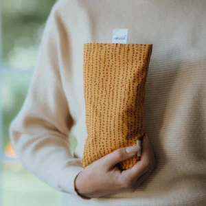 large rectangular shaped eye pillow in a red and orange print