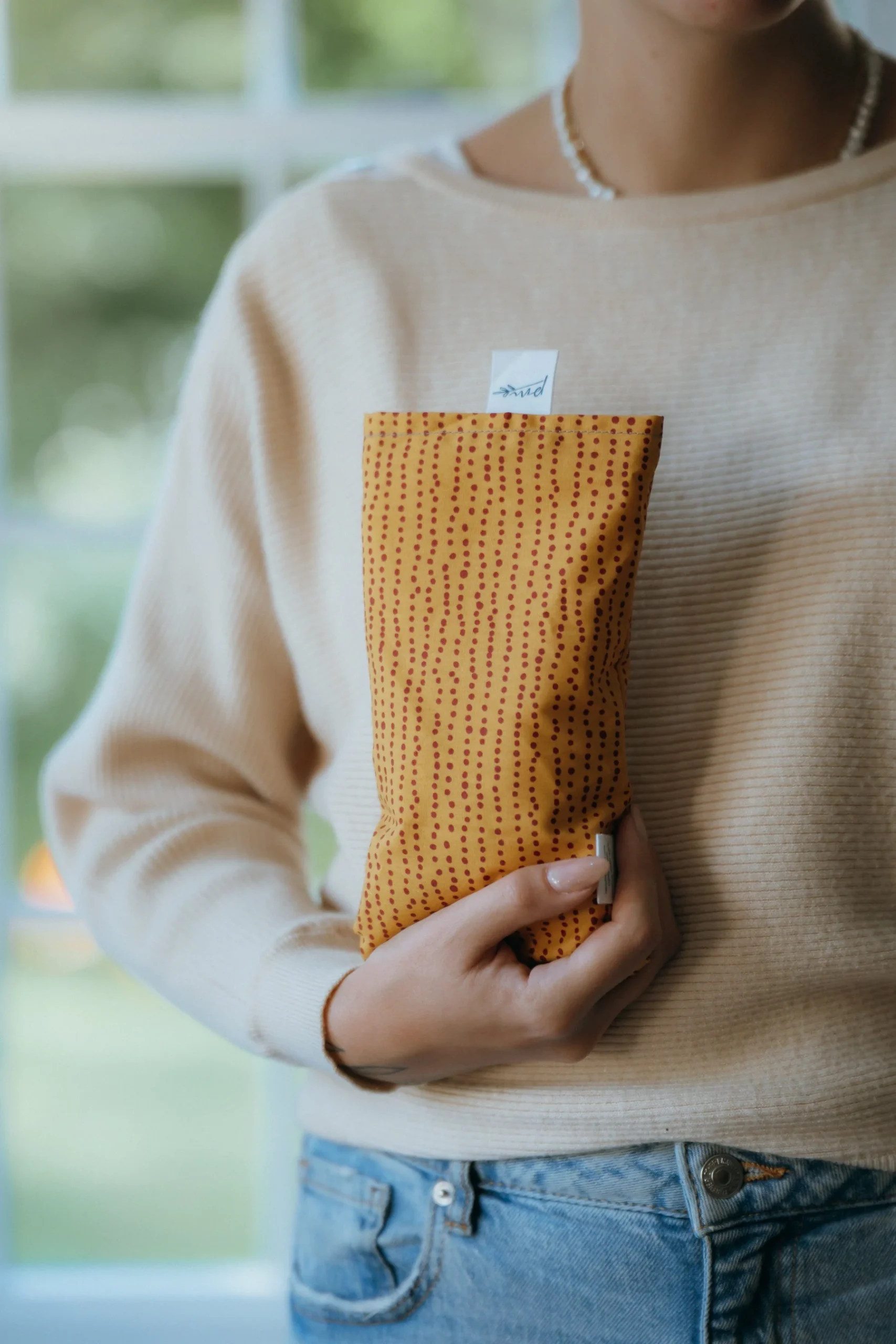 large rectangular shaped eye pillow in a red and orange print