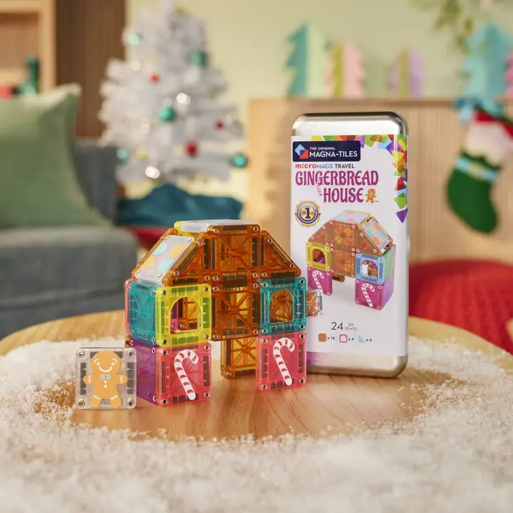 small house made of mini magnatiles with a small tile with a gingerbread man. shown with travel case