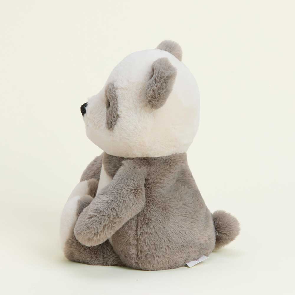side view of panda has cream head with grey ears and patches around eyes