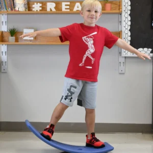 boy rocking on blue concave shaped balance board