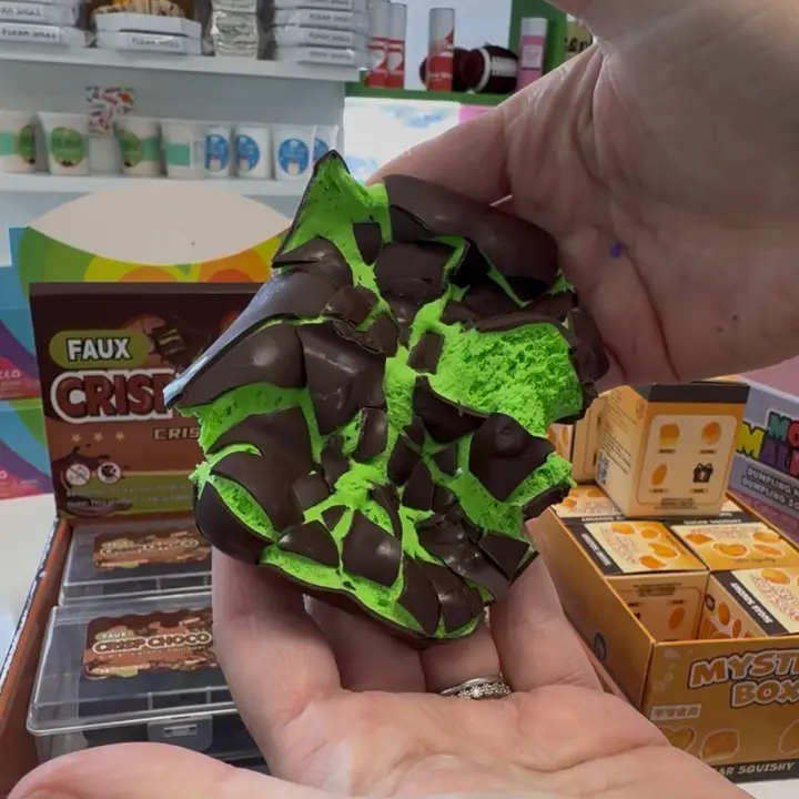 green squish toy with fake chocolate "shell" that is broken