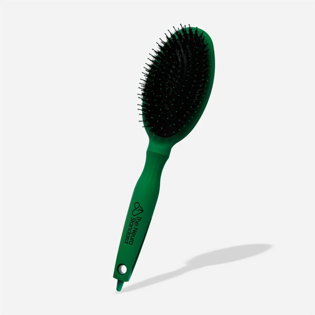green hair brush with black bristles