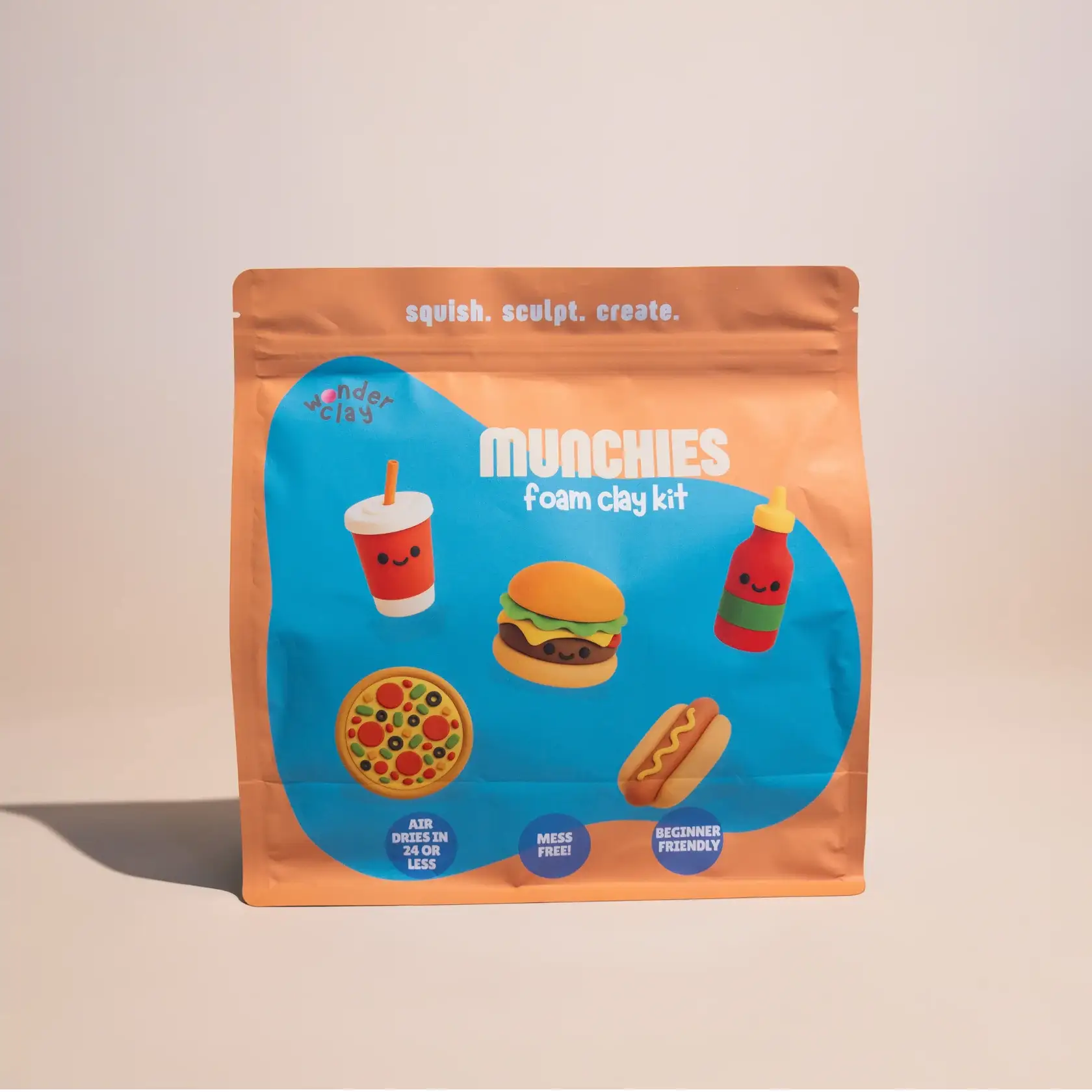 bag of foam clay with a ketchup bottle, hotdog, pizza, hamburger and fountain drink made of clay