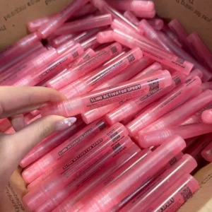 box with many pink spray tubes that say "slime activator spray"