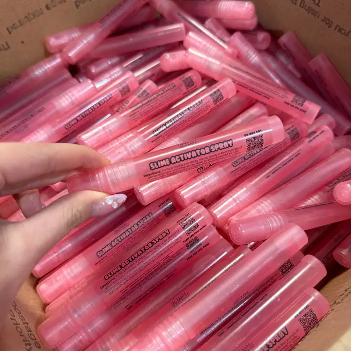 box with many pink spray tubes that say "slime activator spray"