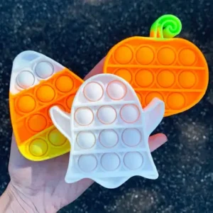 popping fidgets in triangular candy corn in white, orange and yellow, a white ghost, and orange pumpkin with green stem