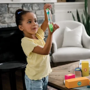 a small girl holding a liquid fidget with different color liquids