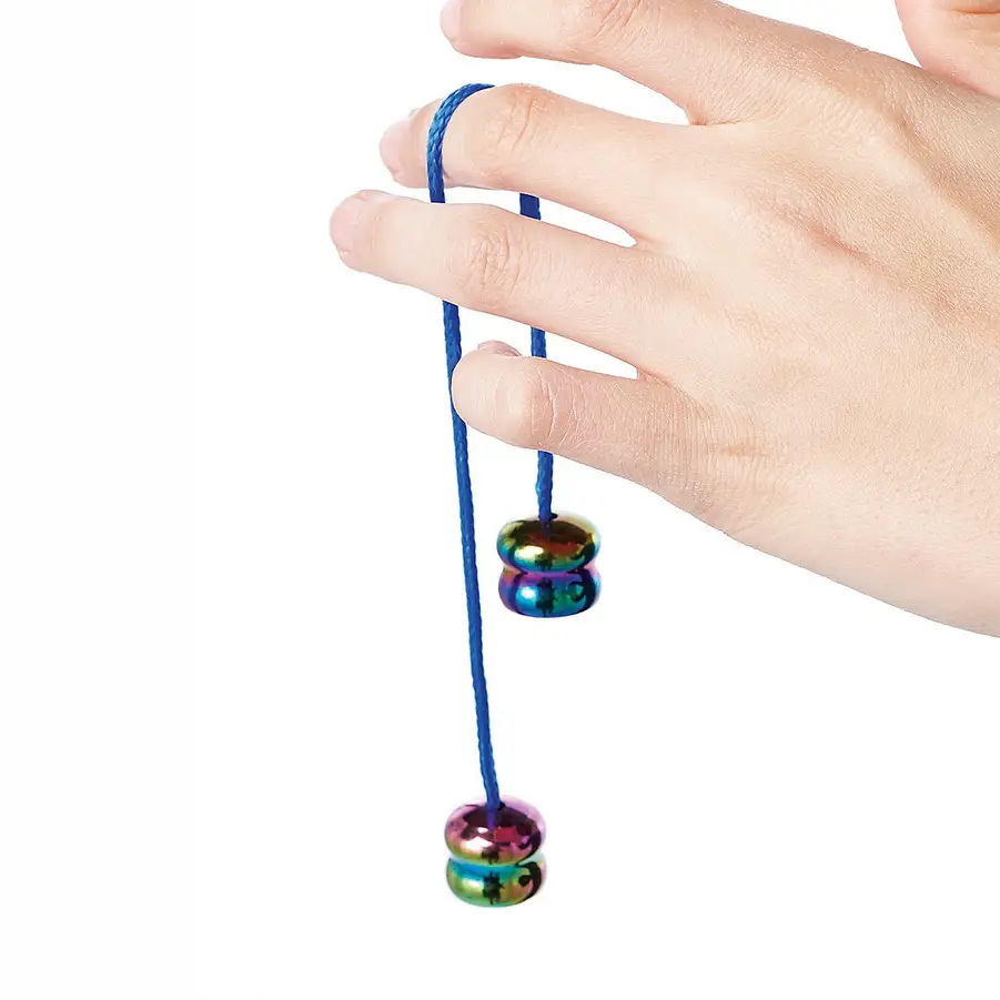 a hand with a string looped around a finger with iridescent weighted beads at the ends