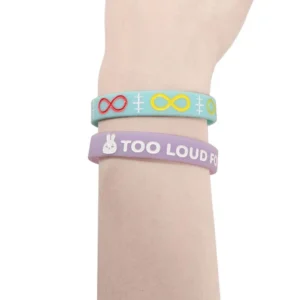 a blue silicone bracelet with red and yellow infinity signs, and a lilac silicone bracelet with a white bunny and the words "Too loud for this bunny"