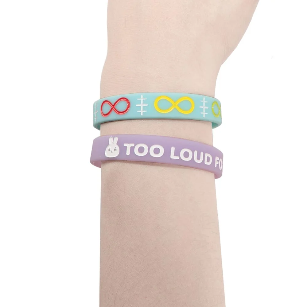 a blue silicone bracelet with red and yellow infinity signs, and a lilac silicone bracelet with a white bunny and the words "Too loud for this bunny"