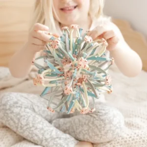 girl holding a pastel ball made of rods and joints