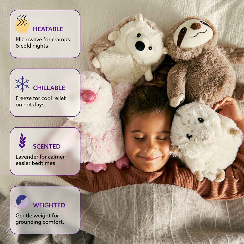 child in bed surrounded by 4 stuffed animals with features listed: heatable, chillable, lavender scented and weighted